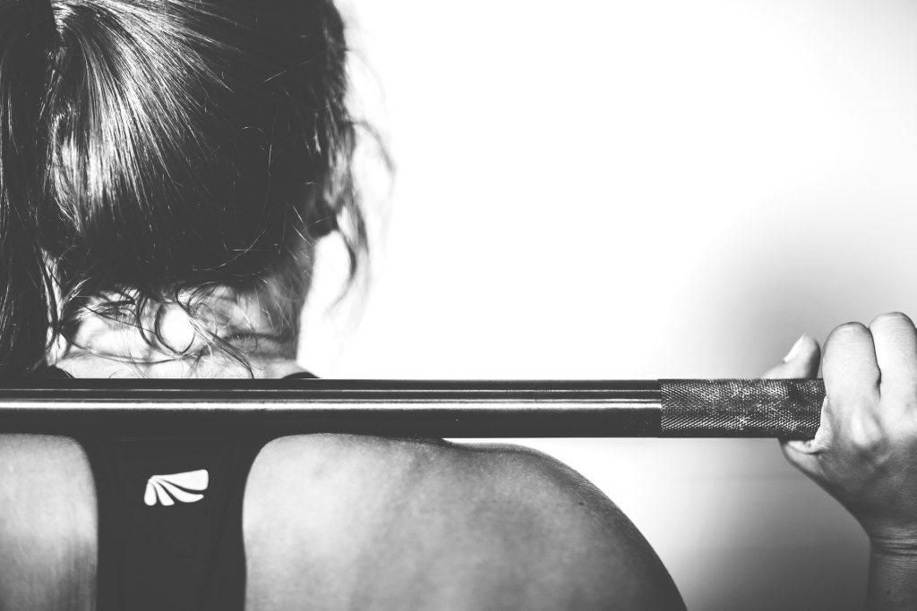 This well-toned woman lifting weights probably gets enough protein