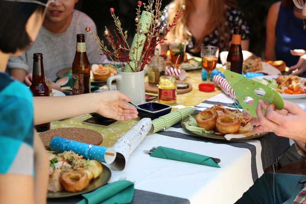 Friends eating dinner at the table can avoid holiday weight gain too.