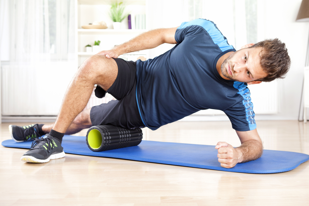 A man doing a basic myofascial release massage getting best results from triggerpoint grid stick.