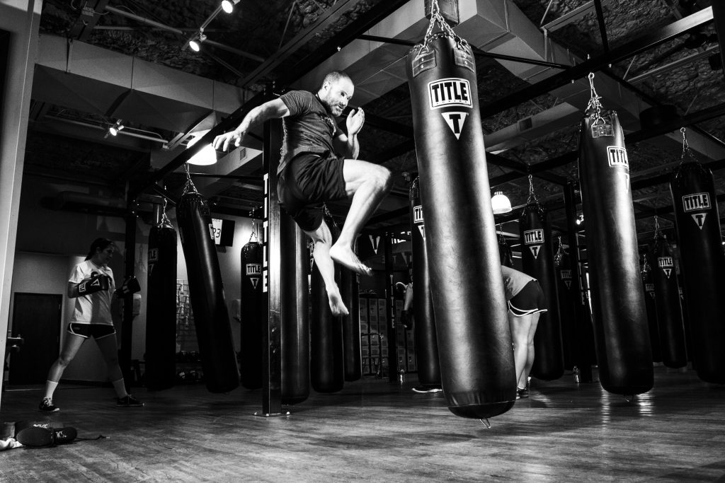 Man kicking heavy bag. 