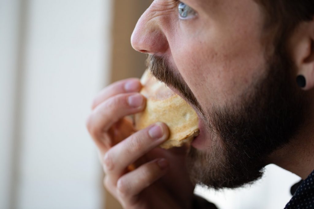 Man eating a muffin.