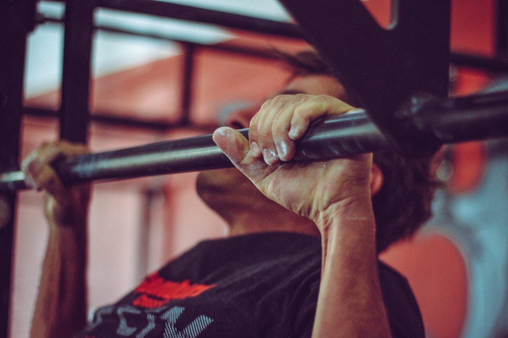 Man doing pull ups. 