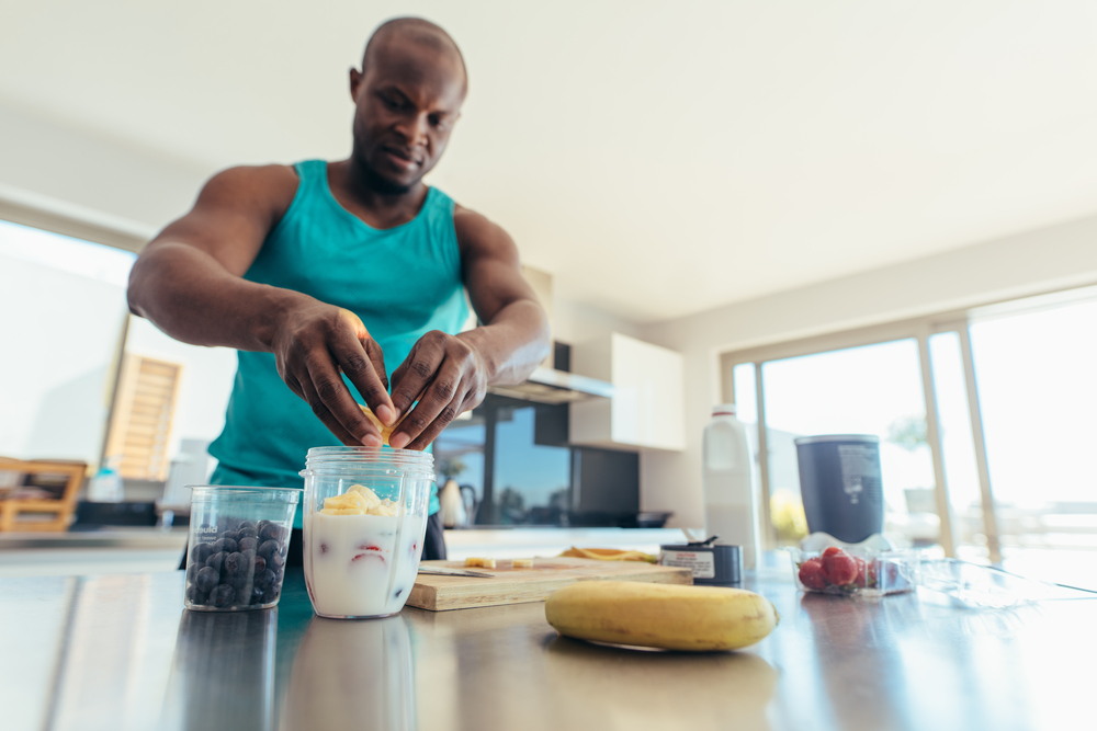 Man preparing a shake in the kitchen. 