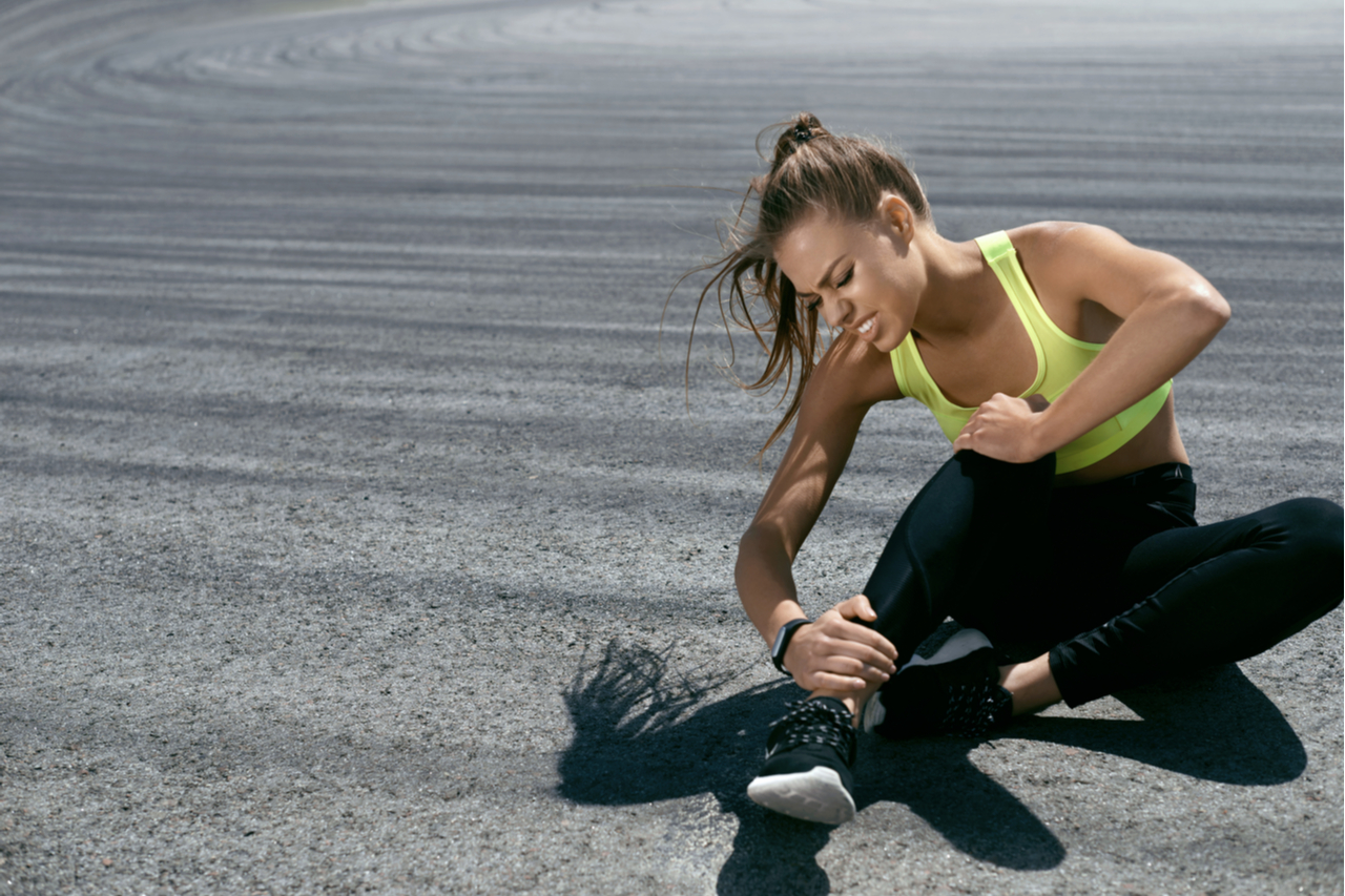 A woman experiencing muscle pain due to inflammation from running.