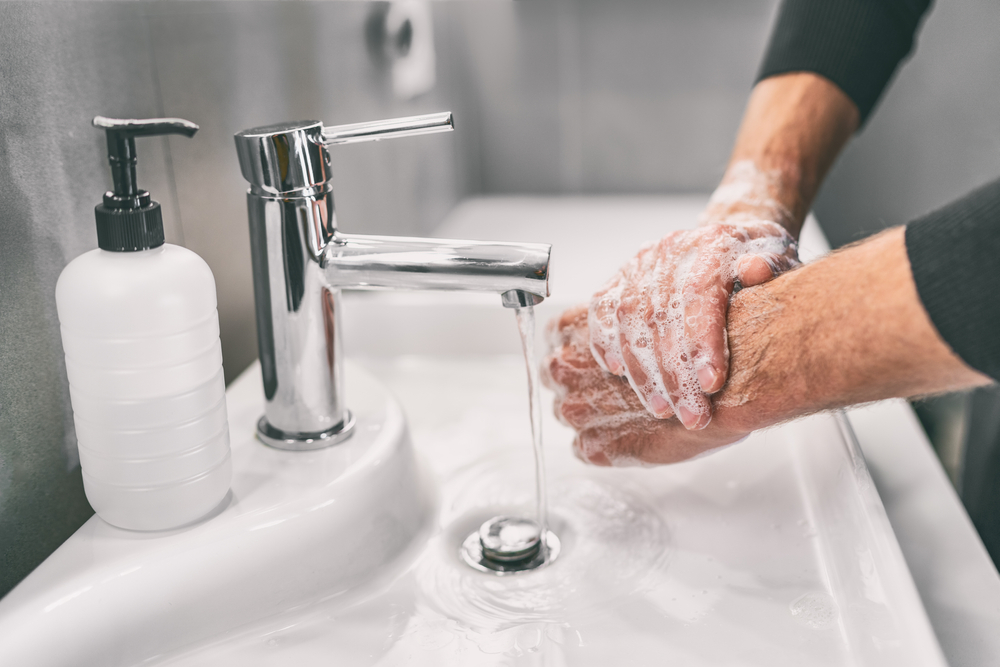 Man washing his hands with soap, a best way to avoid COVID-19.