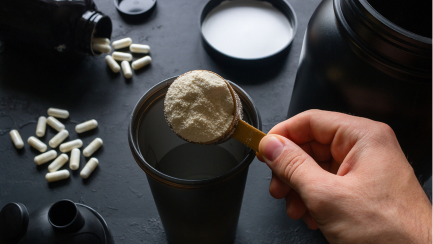 Man preparing supplements before a workout session.