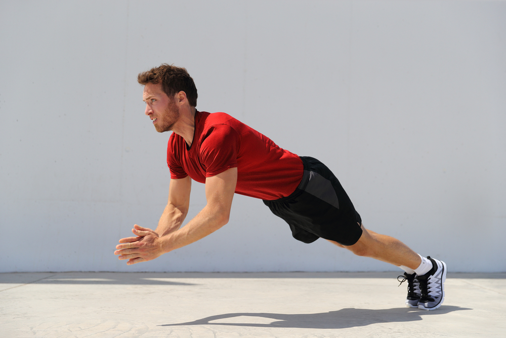  fitness man doing plyometrics push-up exercises explosive workout for muscles training.