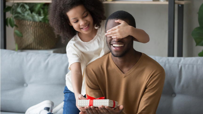 A daughter giving her father a gift during father's day.