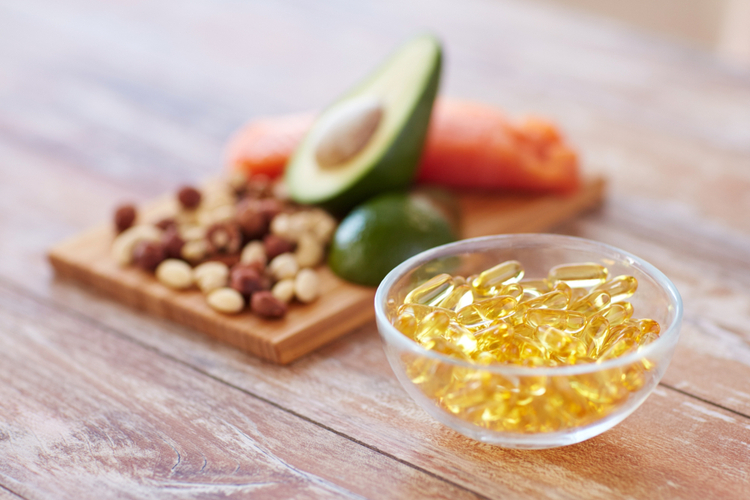 Omega 3 nordic naturals in a bowl next to a selection of omega 3 sources.