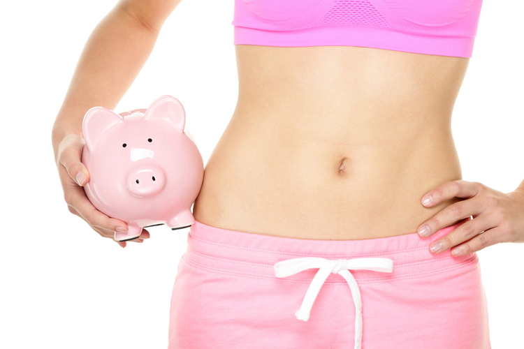 Fit woman with piggy bank..
