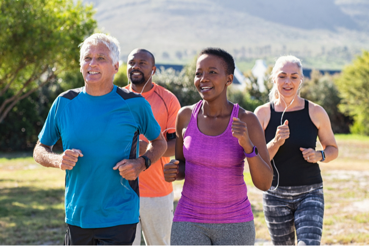 A group of middle-aged and senior people jogging in the park.