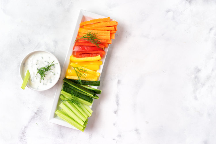 Colorful vegetable sticks with greek yogurt dip.