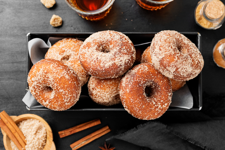 Homemade fresh fried donuts frosted with cinnamon and sugar.