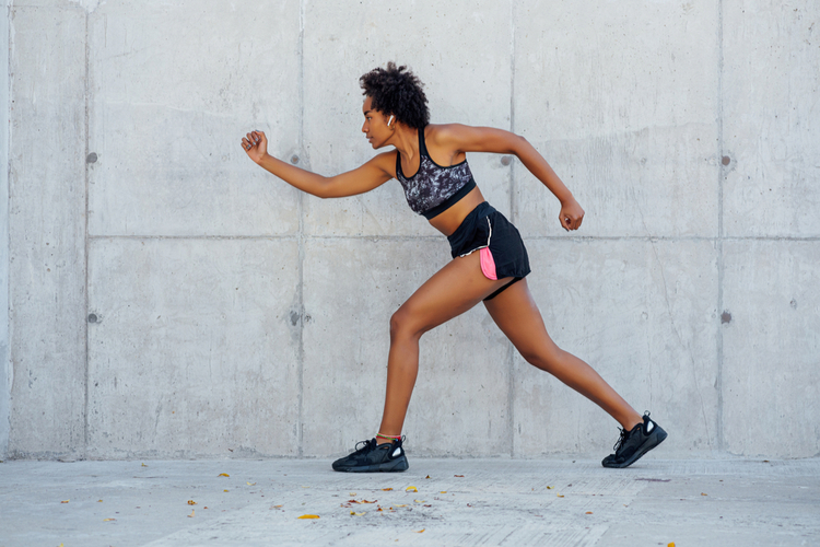 Athletic woman running outdoors.