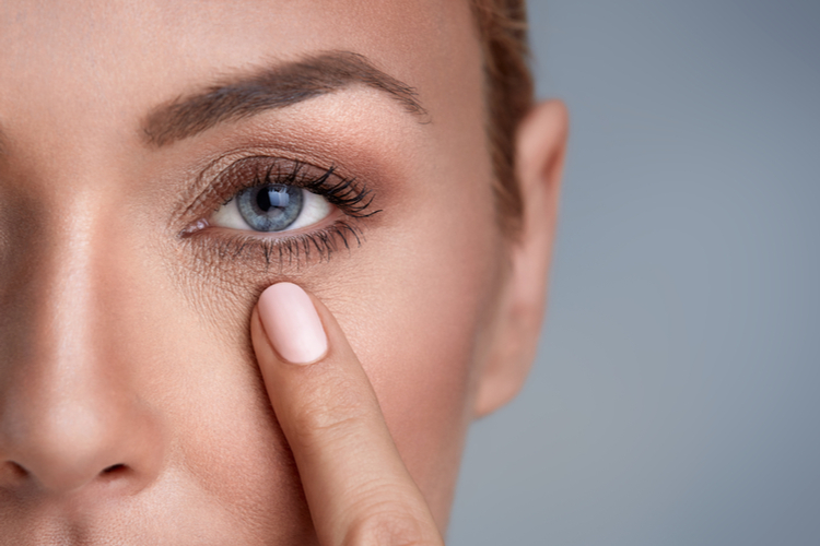 Woman checking wrinkles around the eyes.