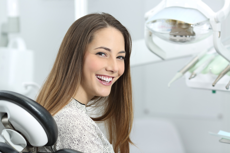 Woman smiling showing her teeth after her dental check-up.