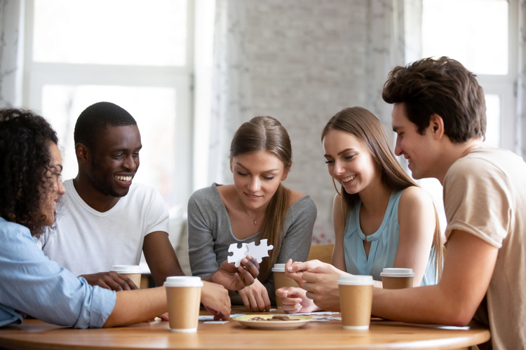 Friends on a table doing brain exercises.