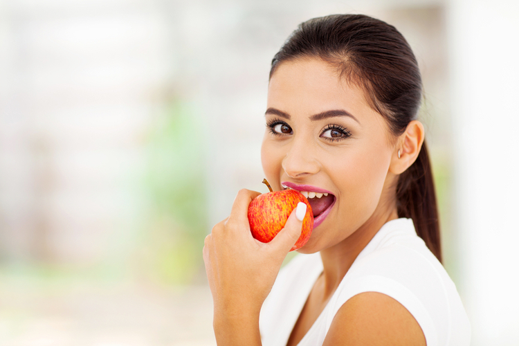 Woman eating an apple.