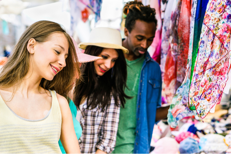 Friends choosing clothes at the weekly cloth market.