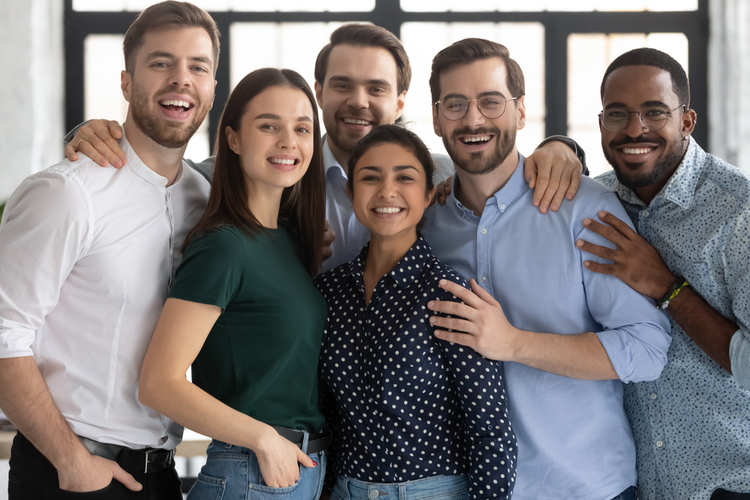 Group portrait of smiling diverse multiracial young businesspeople posing together in office.