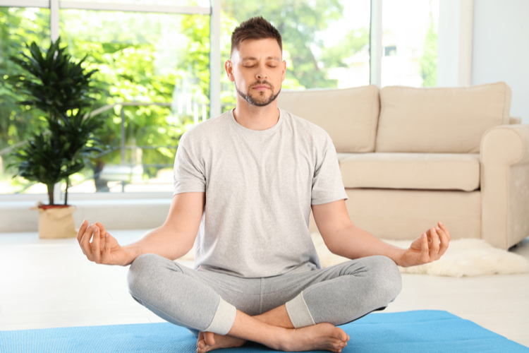 Man meditating at home.