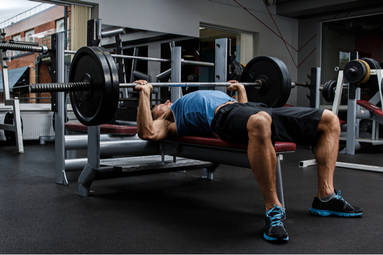 Man during bench press exercise in gym