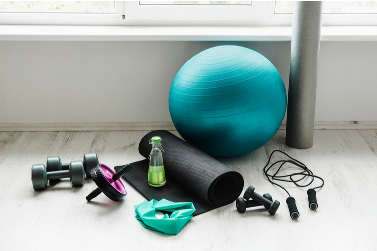 different exercising equipment on white home gym floor.