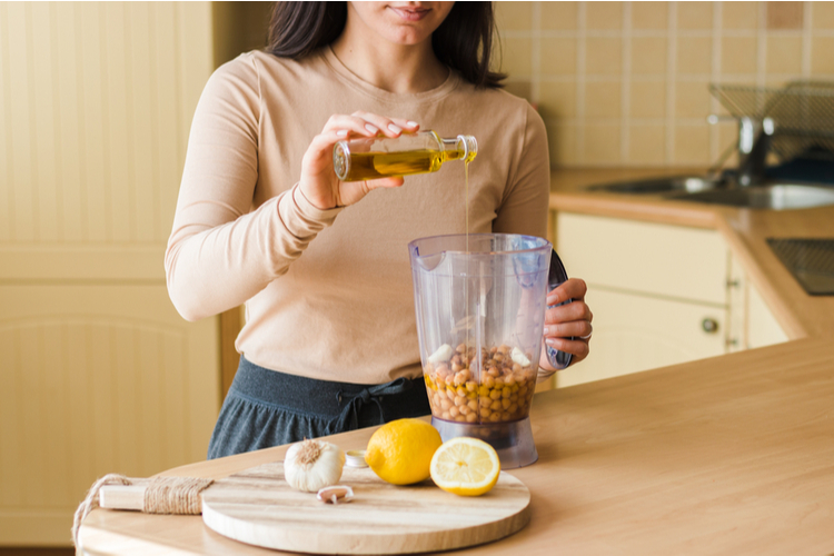 Woman in the kitchen preparing natural vegetarian food.