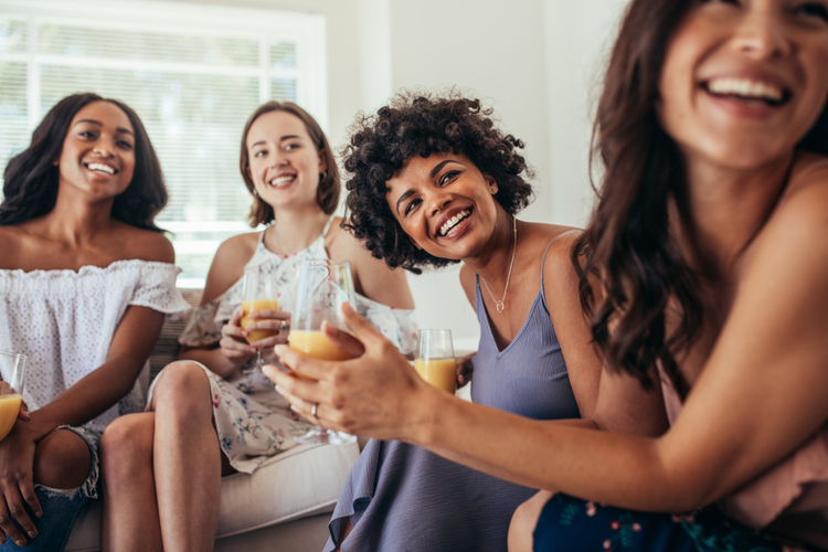 Women friends having a party at home and looking away.