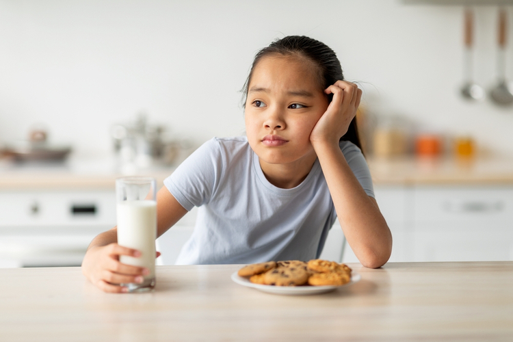 Kid is holding a glass of water