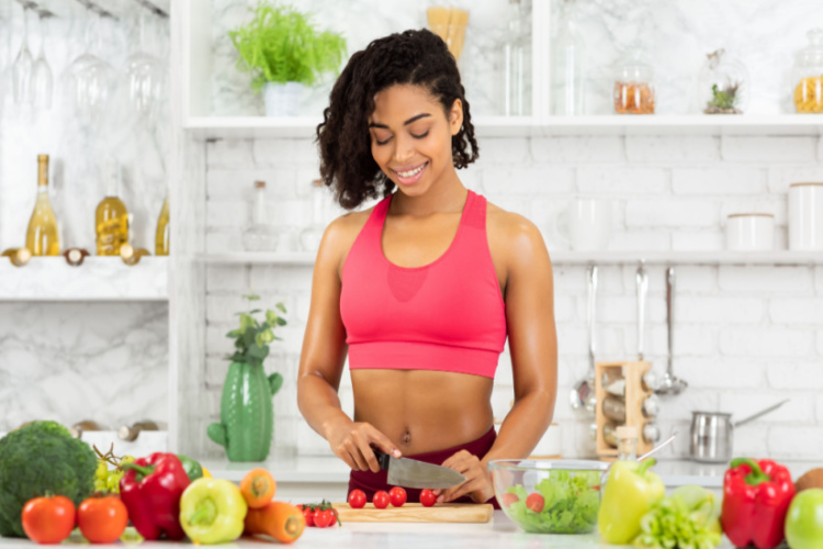 woman preparing vegetable salad in modern kitchen