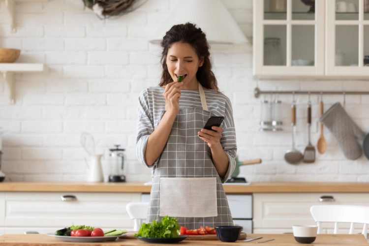 woman in apron stand in modern kitchen searching their diet food