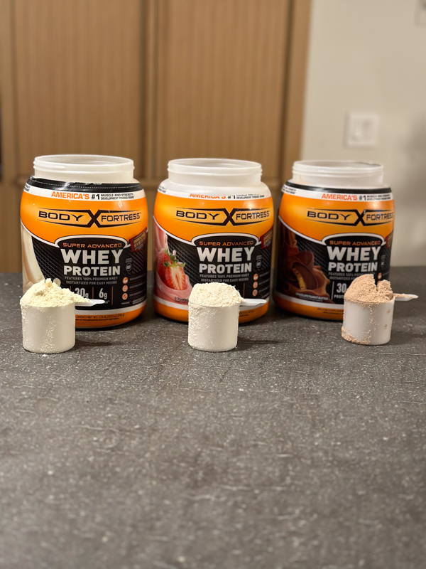 Body Fortress Whey Protein with full scoops of multiple flavors