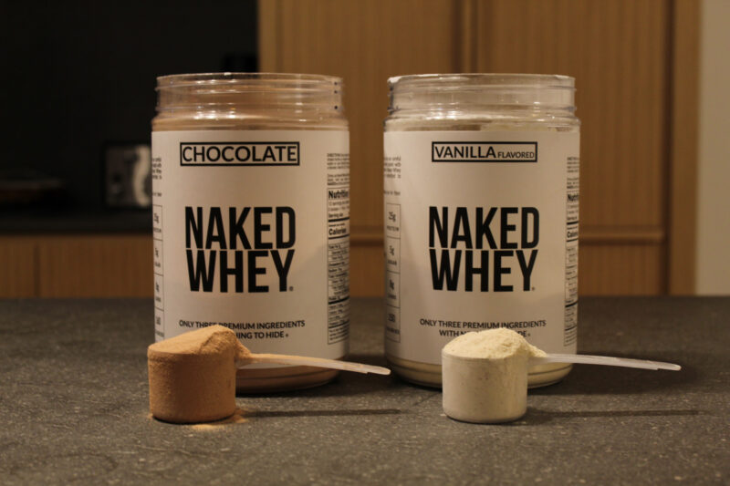 Nakey whey protein close up of two flavors with full scoops